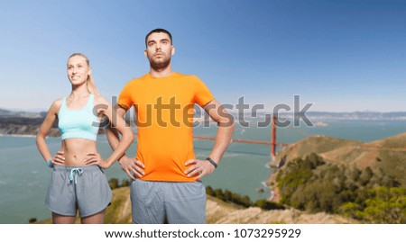 fitness, sport and healthy lifestyle concept - happy couple exercising over golden gate bridge in san francisco bay background