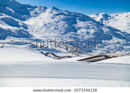 Road to Val Thorens, snow-capped mountains, ski slopes, ski lifts, car parking. Three Valleys, France.