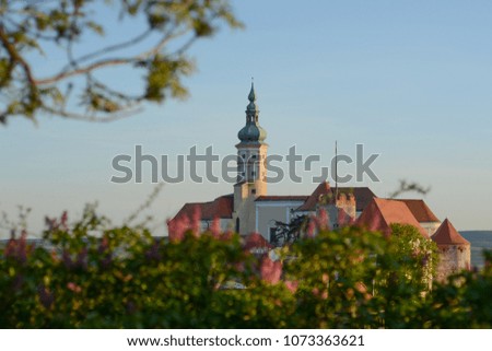 Mikulov castle / clock tower at the sunset with nice blue smooth sky , Mikulov south Moravia , Czech republic , summer autumn spring touristic destination