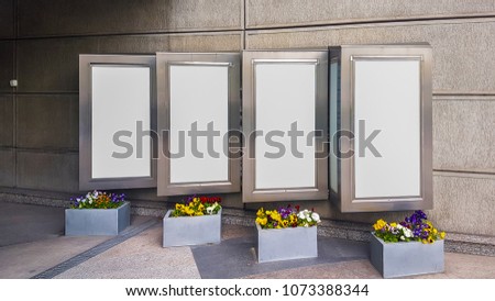 Four City Urban White Blank Advertisement Display Banner Mock Up With Metal Frames and Flowers on The Street.Isolated Template Clipping Path