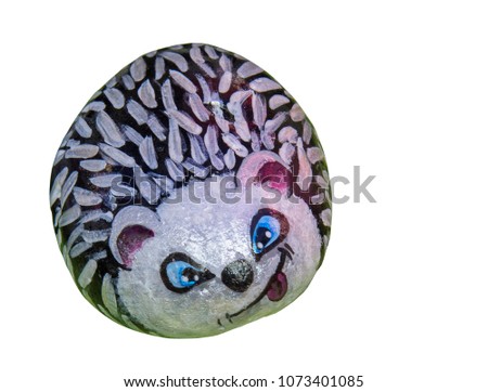 Funny drawing of hedgehog on sea pebble. Isolated