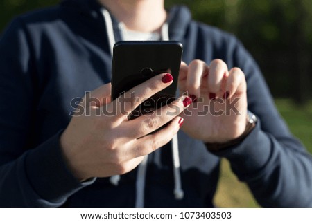 Girl typing on mobile phone