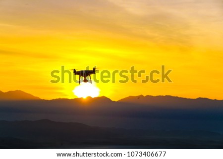 Robot Drone quadcopter flying on mountain sunset silhouette scene nature landscape