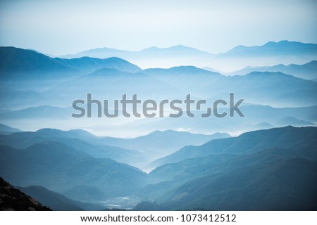 Dawn of the mountain with the sea of clouds Royalty-Free Stock Photo #1073412512