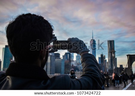 A guy taking picture of New York Skyline