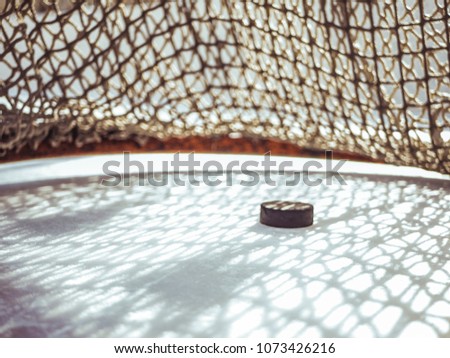 close up hockey goal puck in the net score