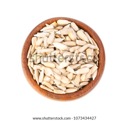 Sun flower seed on wood bowl isolated on white background