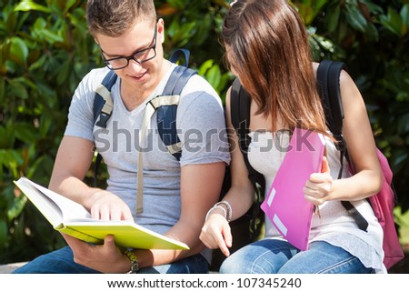 Portrait of two students talking in a park