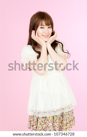 Beautiful young woman on pink background. Portrait of asian.