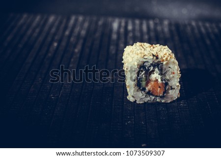 Delicious sushi on a black table