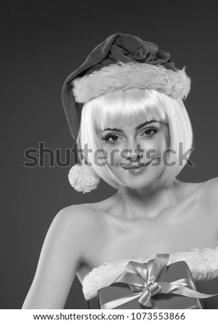 Christmas woman with gift box blonde female portrait. Studio shot.