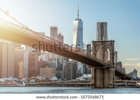 Lower Manhattan Panoramic Skyline and Brooklyn Bridge during sunset. New York City, USA.