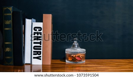Vintage Pile Of Books In Color Covers And Accessories On Wooden Deck And Black Grunge Wall Texture. Image For Templates, Placards, Banners, Presentations, Reports, Card And Wallpaper. etc.