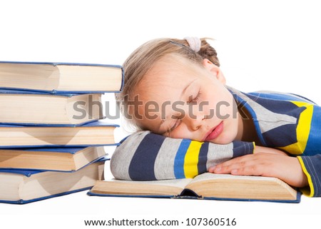 Portrait of cute schoolgirl  sleeping over the book on isolated white background