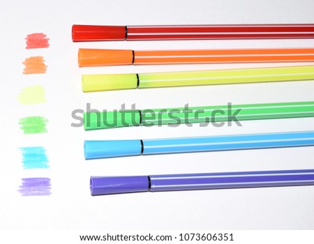 A photo of a rainbow painted with colored felt-tip pens. Symbols of LGBT people.