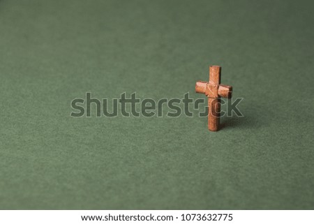 Christian cross on green background with space for writing