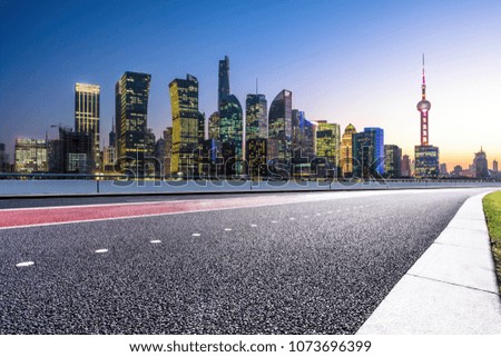 empty asphalt road with city skyline