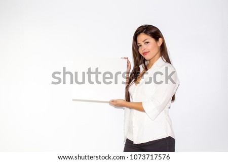 Beautiful girl hold a white board billboard smiling and is amazed surprised and happy