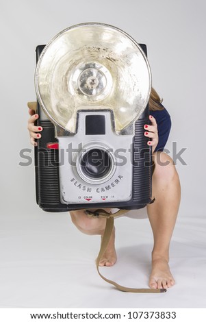 Girl holding a giant vintage clown camera