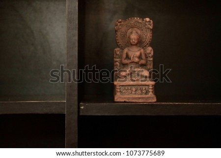 Buddha figurine in black cupboard