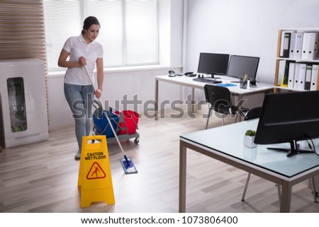 Wet Floor Caution Sign And Cleaning Equipments On Floor
