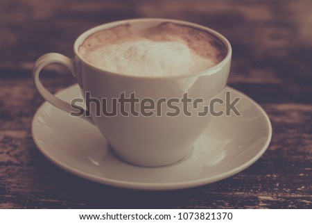 Coffee cup on table - vintage style picture effect
