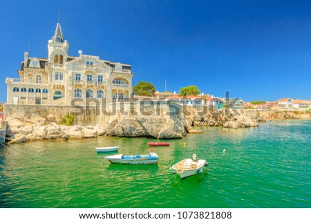 Scenic landscape of abandoned Palace Seixas and boats on the waterfront of Cascais, Lisbon Coast in Portugal. Praia da Rainha on the distance. Turquoise sea in summertime. Copy space with blue sky. Royalty-Free Stock Photo #1073821808