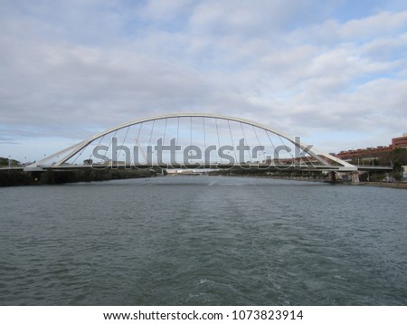 Puente de la Barqueta, or Puente Mapfre, with the Alamillo Bridge visible in the background, located in Seville, Spain