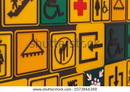 Various signs and navigation elements with arrows: cafe, shower room, restrooms, emergency exit, medical point