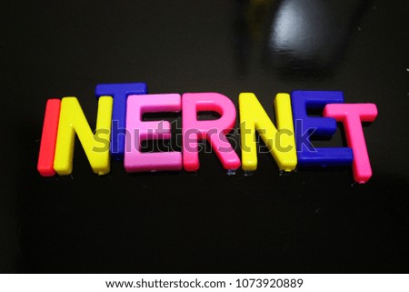 the word internet uses a toy letter with a black background