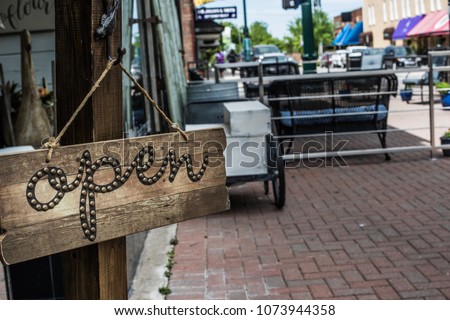 Open sign in front of a shop