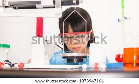 Science kids concept, kids learning science in laboratory on gray whit background. Cute child kid playing and funny in knowledge about lab experiment and instrument of science to be scientist. 