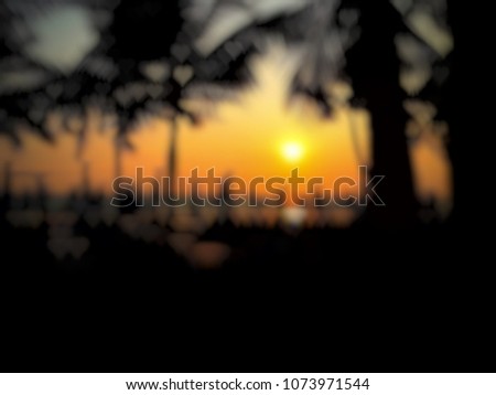 Abstract Background image blur of the beach and Coconut tree with light orange