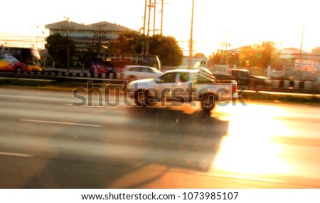 Blurred cars running on the street in the evening.