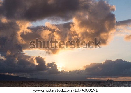 Cruise Ship under Billowing Clouds Sunset in Maui, Hawaii.