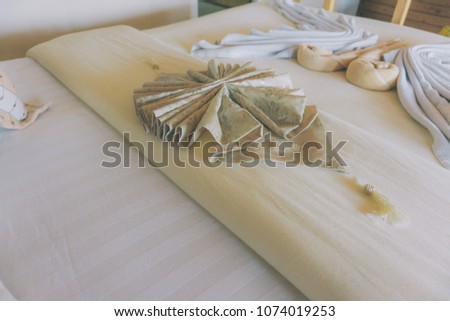 The fabric folds on the bed in the hotel.