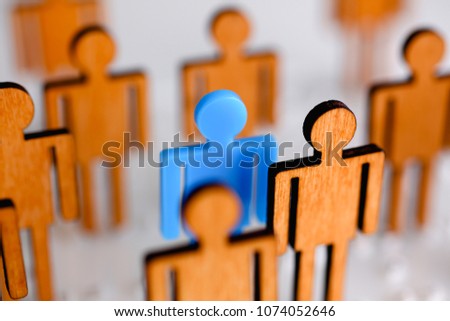 Little plastic blue toy figure stand out from unit crowd line closeup. One worker against odd hr job shift head hunter rare disease unit dismissal retire lgbt media virus epidemic success concept Royalty-Free Stock Photo #1074052646