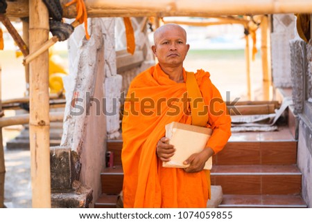 Monks in Thailand with a book