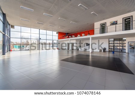 Interior of empty car dealership Royalty-Free Stock Photo #1074078146