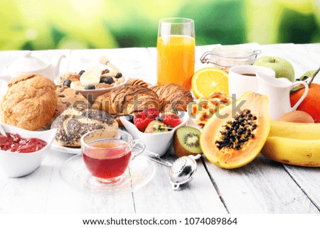 Breakfast served with coffee, orange juice, croissants and fruits. Balanced diet.