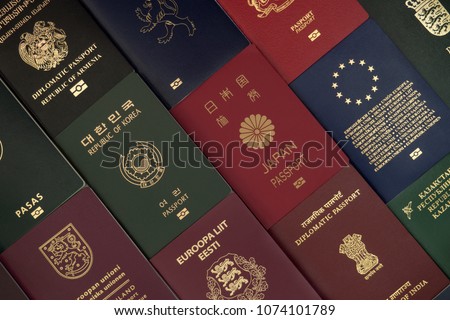 Different foreign passports from many countries by the world as colorful background Royalty-Free Stock Photo #1074101789