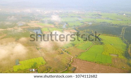 Mist over countryside on morning time at Northern Thailand background,,Aerial view from Drone flight at Northern Thailand on morning time background.