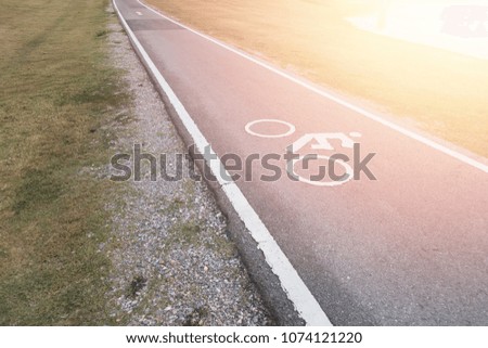 Bicycle lane sign with light-sunset on road , safety zone bike in public park.