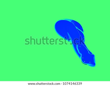 Background texture. Photo of blue acrylic paint on a green background. A three-dimensional blue blob.