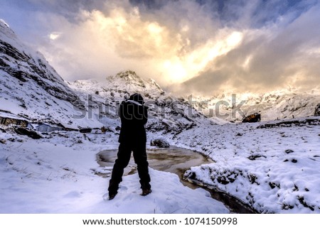 Trekker taking photo of Machapuchhare, on the Annapurna Base Camp(ABC) Trek, Nepal,Himalaya.