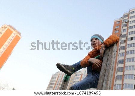 Kid on horizontal bar at outdoor playground