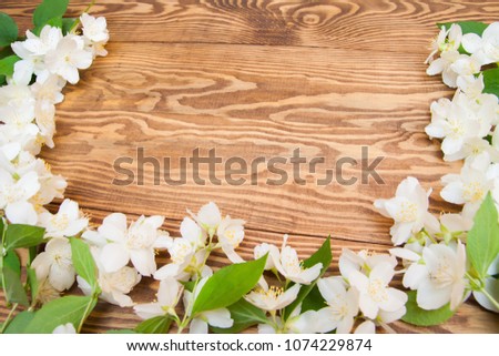 white small flowers. greeting card, blank on shaby wooden background.