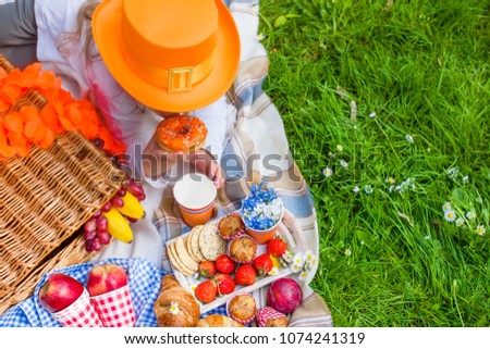 Picnic on the green grass. Orange accessories. Celebration of the King's Day in the Netherlands. Happy weekend
