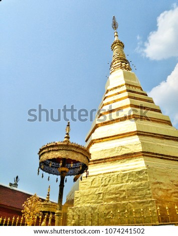 Vertical bright image golden pagoda of Wat Prathat Cho Hae or Prathat Cho Hae temple at Phrae,Thailand. 