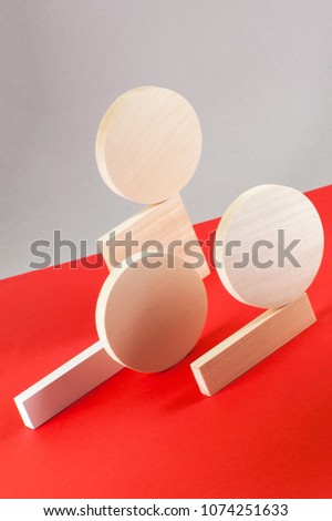 Abstraction from wooden geometric figures on a gray-red background.
